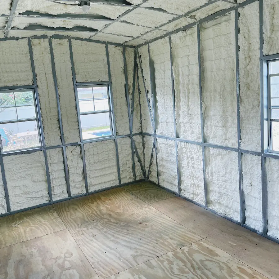 Closed-cell spray foam insulation applied to wall cavities in a residential project in Amityville
